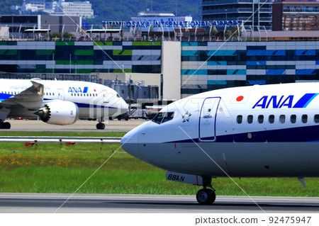 Osaka International Airport, a passenger plane taking off and landing Osaka International Airport, a passenger plane taking off and landing 92475947