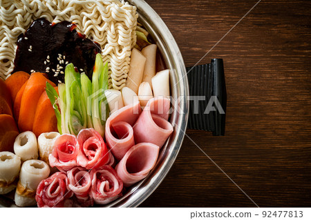 Budae Jjigae or Budaejjigae (Army stew or Army base stew). It is loaded with Kimchi, spam, sausages, ramen noodles and much more 92477813