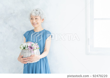 Senior woman with flowers 92478220