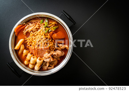 Budae Jjigae or Budaejjigae (Army stew or Army base stew). It is loaded with Kimchi, spam, sausages, ramen noodles and much more Budae Jjigae or Budaejjigae (Army stew or Army base stew). It is loaded with Kimchi, spam, sausages, ramen noodles and much more 92478523
