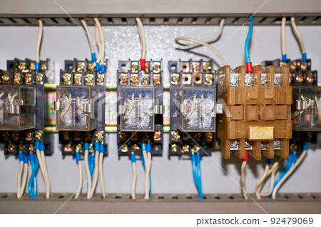 Several old relays with connected colored wires. Several old relays with connected colored wires. 92479069