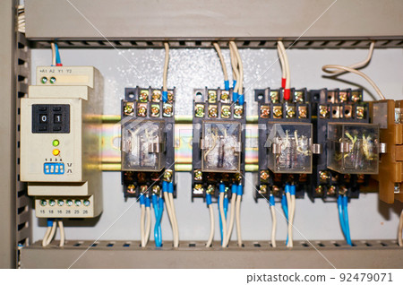 Several old relays with connected colored wires. Several old relays with connected colored wires. 92479071