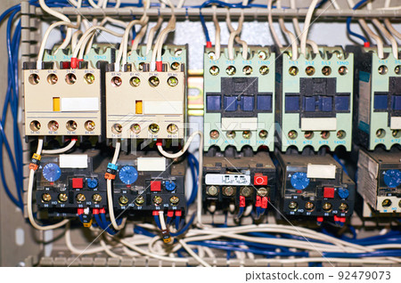 Several old relays with connected colored wires. Several old relays with connected colored wires. 92479073