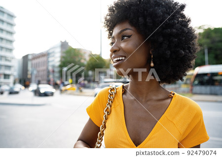 Portrait of a young african american woman smiling standing at the city. Portrait of a young african american woman smiling standing at the city. 92479074