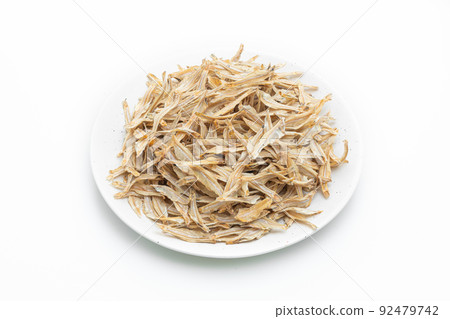 dried small crispy fish on white background dried small crispy fish on white background 92479742