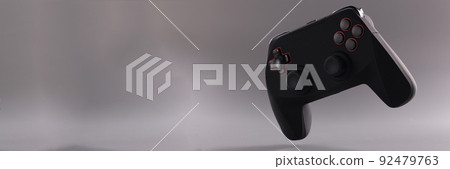 Black game joystick with buttons on gray background 92479763