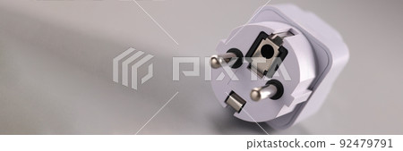 White electrical plug on gray background. Electrical safety White electrical plug on gray background. Electrical safety 92479791