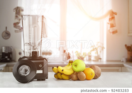 Blender, fruits and kitchen space. Sun flare Blender, fruits and kitchen space. Sun flare 92483283