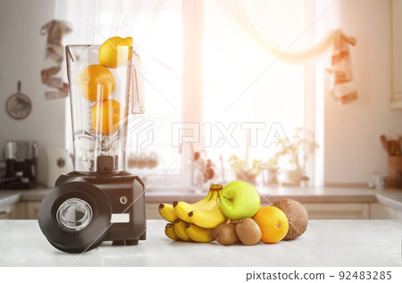Blender, fruits and kitchen space. Sun flare 92483285