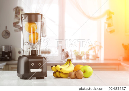 Blender, fruits and kitchen space. Sun flare Blender, fruits and kitchen space. Sun flare 92483287