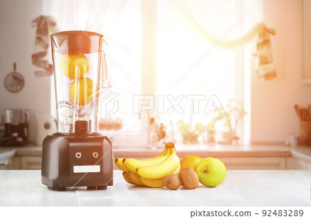 Blender, fruits and kitchen space. Sun flare Blender, fruits and kitchen space. Sun flare 92483289