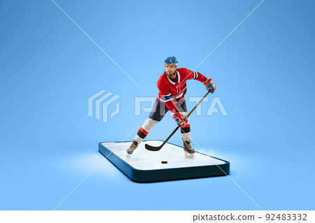 Professional hockey player with hockey stick getting ready to bullet standing on ice on 3d phone screen over blue background. Online watching sports events. Collage 92483332