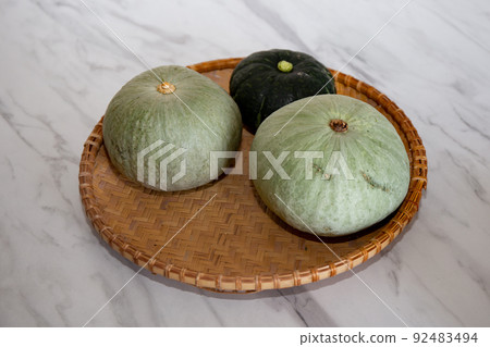 Table photo of 3 freshly picked pumpkins 92483494
