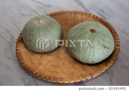 Table photo of 2 freshly picked pumpkins 92483495