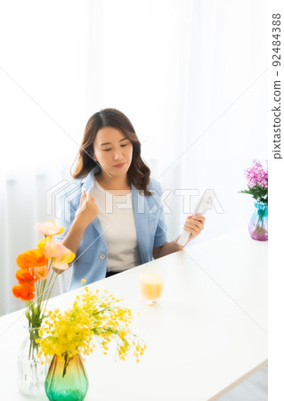 一個用電風扇尋求涼爽的女人 92484388