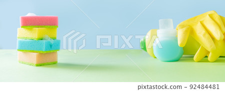 Cleaning concept - cleaning supplies on pastel yellow background Cleaning concept - cleaning supplies on pastel yellow background 92484481