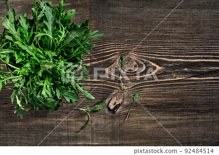 Fresh green arugula on wooden table Fresh green arugula on wooden table 92484514