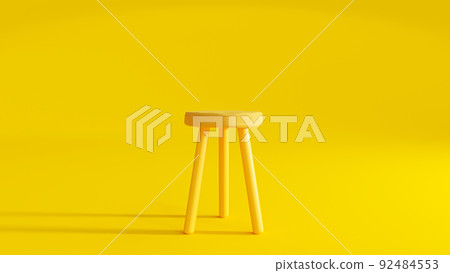 Yellow three legged chair on yellow background light from the side. 92484553
