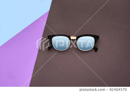 Minimal style. Minimalist Fashion photography. Fashion summer is coming concept. Sunglasses on a colorful background Minimal style. Minimalist Fashion photography. Fashion summer is coming concept. Sunglasses on a colorful background 92484570
