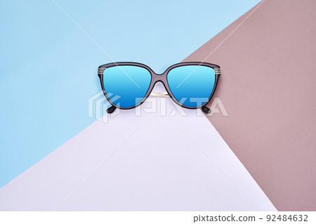 Minimal style. Minimalist Fashion photography. Fashion summer is coming concept. Sunglasses on a colorful background Minimal style. Minimalist Fashion photography. Fashion summer is coming concept. Sunglasses on a colorful background 92484632