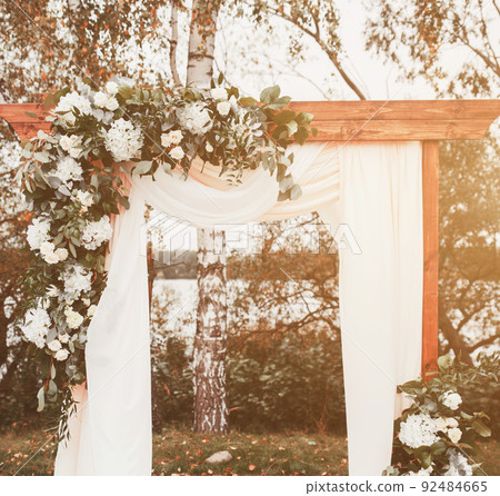 Wedding arch decorated with cloth and flowers Wedding arch decorated with cloth and flowers 92484665