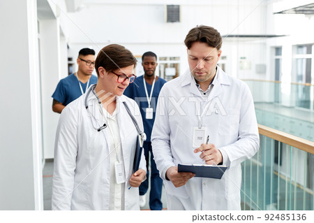 Doctors Walking in Clinic Doctors Walking in Clinic 92485136