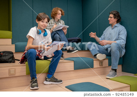 A teacher and his students discussing details of the project 92485149