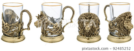 Metal brass Lion Animal cup holder with empty glass. Close up Three views isolated on white background. used for hot tea or coffee on trains. Vintage decorative souvenir. 92485252
