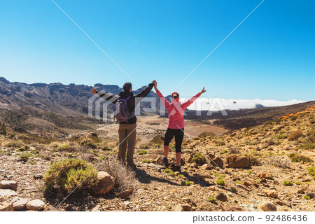 sporty couple on top of mountain. Tenerife Canary sporty couple on top of mountain. Tenerife Canary 92486436