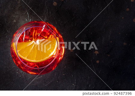 Aperol cocktail with an orange slice, Italian summer cold drink, top shot Aperol cocktail with an orange slice, Italian summer cold drink, top shot 92487396