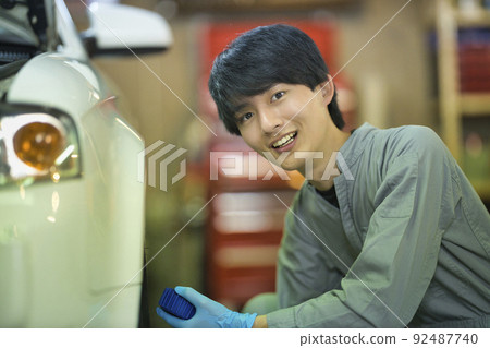 Auto mechanic working in a factory 92487740