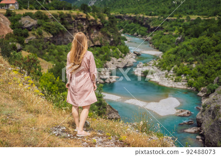 Woman tourist on background of purest waters of the turquoise color of the river Moraca flowing among the canyons. Travel around Montenegro concept Portrait of a disgruntled girl sitting at a cafe Woman tourist on background of purest waters of the turquoise color of the river Moraca flowing among the canyons. Travel around Montenegro concept Portrait of a disgruntled girl sitting at a cafe 92488073