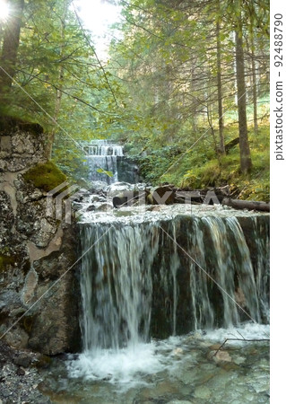 Waterfall at mountain hiking tour to Tegelberg mountain, Bavaria, Germany 92488790