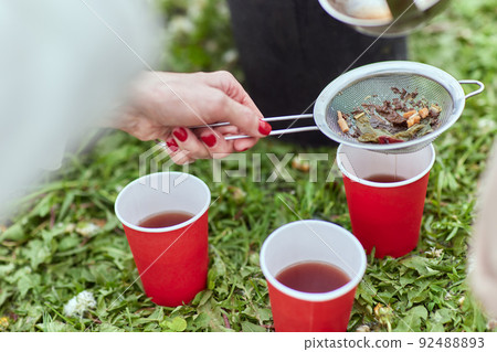 Natural herbal tea served with honey outside in nature along with a book. living a healthy life close to nature. 92488893