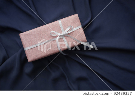Navy blue cloth background with pink glitter gifts and bird's-eye view drapes Navy blue cloth background with pink glitter gifts and bird's-eye view drapes 92489337