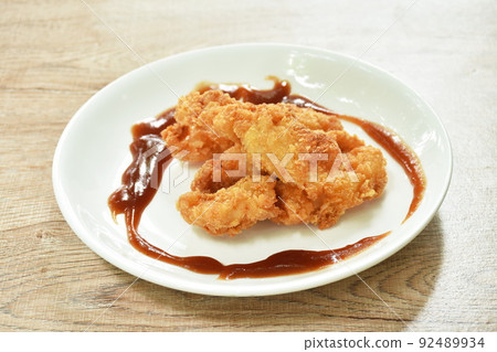 crispy fried chicken fillet with bread crumb and egg yolk on plate dipping ketchup 92489934