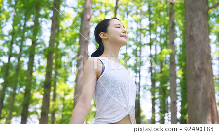 Woman relaxing in the woods Woman relaxing in the woods 92490183