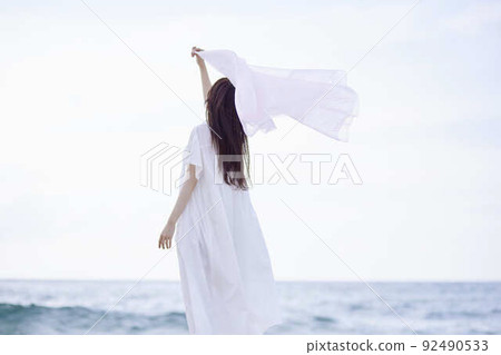 A beautiful woman dancing with a pink cloth 92490533