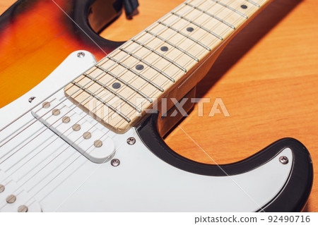 Close-up of a guitar neck and strings with body 92490716