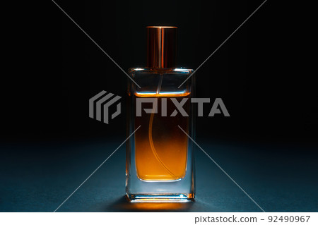 Close up of glass bottle of male perfume on dark background. Style perfumery template Close up of glass bottle of male perfume on dark background. Style perfumery template 92490967