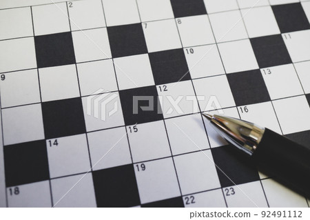 Crossword puzzle and ballpoint pen close-up 92491112