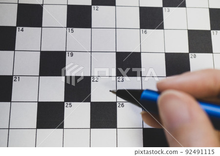 Crossword puzzle close-up at hand with a mechanical pencil 92491115