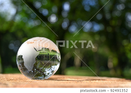Image of glass globe placed on stump SDGs, environmental protection, peace, etc. 92491352