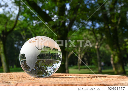 Image of glass globe placed on stump SDGs, environmental protection, peace, etc. 92491357