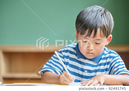 Elementary school boy studying at school Elementary school boy studying at school 92491745
