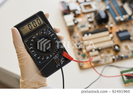 Engineer Holding Multimeter Closeup 92491960