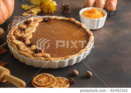 Warming coffee and homemade pumpkin pie for autumn cozy day. 92492502