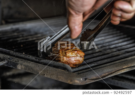 An organic marinated duck fillet being grilled An organic marinated duck fillet being grilled 92492597