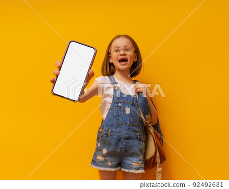 kid showing screen of mobile phone 92492681