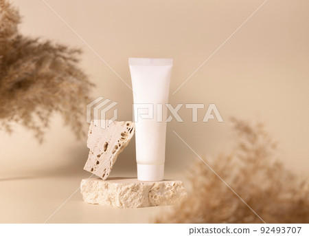 White plastic cream tube on stone near dry pampas grass on light yellow, Mockup White plastic cream tube on stone near dry pampas grass on light yellow, Mockup 92493707